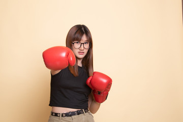 Young Asian woman with red boxing gloves.