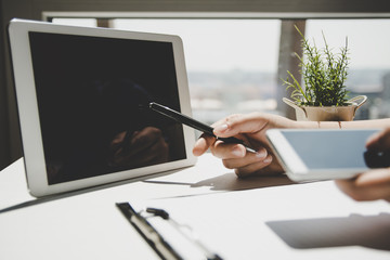 Closeup of person pointing pen at tablet computer screen