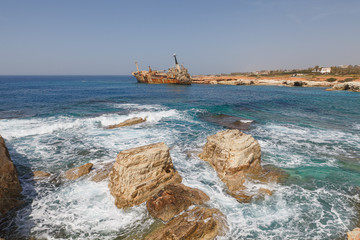 Rusty abandoned ship near Paphos beach. The most attractive shipwreck of Cyprus island. Sunny...