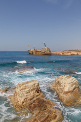 Rusty abandoned ship near Paphos beach. The most attractive shipwreck of Cyprus island. Sunny summer day.