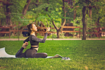 Young Caucasian woman doing yoga in the Park.