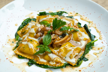 close up of home made porcini mushrooms ravioli with spinach