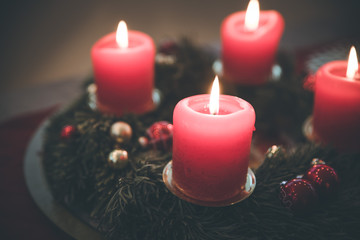 Traditional Christmas decoration: Advent wreath with red lights