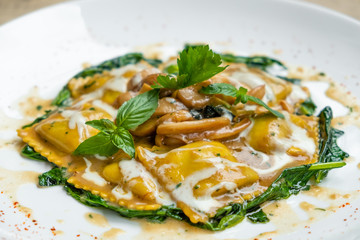 close up of home made porcini mushrooms ravioli with spinach