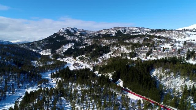 AERIAL. Train Oslo - Bergen in mountains. Hordaland, Norway. 