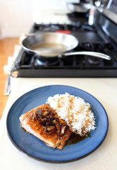 Plate of steelhead trout with teriyaki demi-glace and rice.