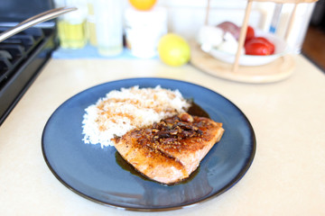 Plate of steelhead trout with teriyaki demi-glace and rice.