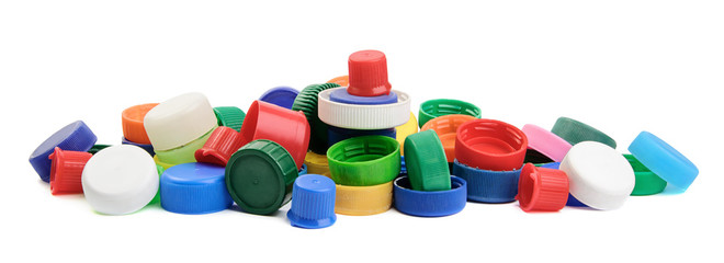 Pile of colorful plastic screw caps of plastic bottles isolated on white background. Recycling concept.