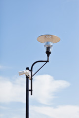 Lamppost on a cloudy sky background