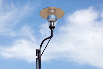 Lamppost on a cloudy sky background