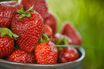 close up of fresh red strawberries in bowl