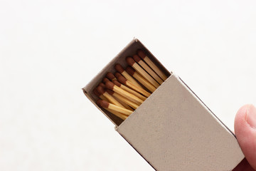 outdoor matchboxes closeup on white background. Matchbox in hand. Open matchbox in hand