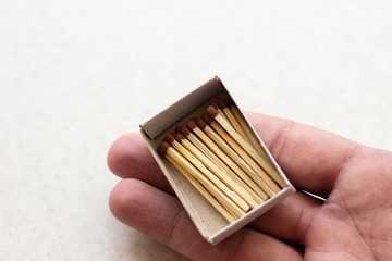outdoor matchboxes closeup on white background. Matchbox in hand. Open matchbox in hand
