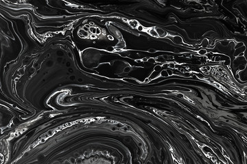 Abstract black marble texture background. Oil, acrylic paint mix pattern.