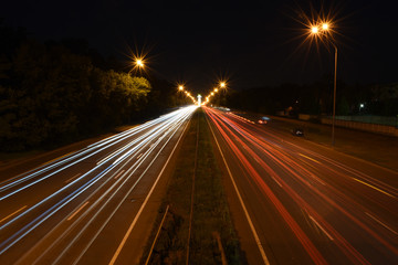 Fototapeta na wymiar Evening traffic streaks by on a highway
