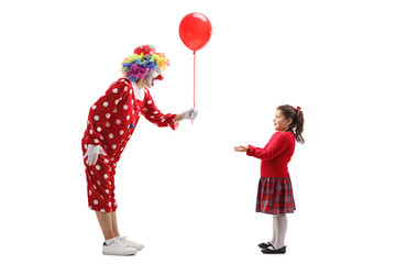 Clown giving a balloon to a little girl
