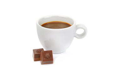Cup of coffee and chocolate candies isolated on white.