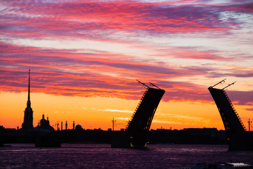 Fototapeta na wymiar The bridges are erected at dawn in St. Petersburg. Peter Romance. Sight of Peter. Neva River. Dawn in the city. White Nights.
