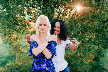 young guy scares from behind relaxing young girl