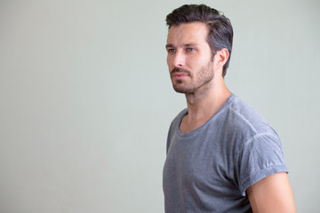 Studio shot of handsome bearded man thinking