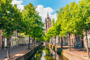Canal with Leaning Church Tower in Delft Netherlands - obrazy, fototapety, plakaty
