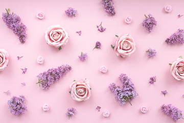 Pink rose and lilac flowers on pink background, flat lay, top view