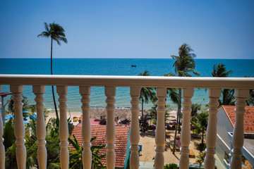 Phu Quoc island, Vietnam - March 31, 2019: Balcony railing at the hotel, view of the sea and the beach. Growing palm trees on the coast recreation area