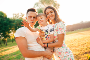 happy photos of a young family.mom dad and son