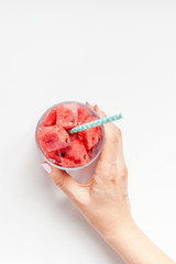 Woman hands with crushed watermelon in glass