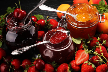 assortment of jams, seasonal berries, apricot, mint and fruits. marmalade or confiture