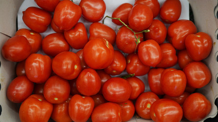 red tomatos in box in supermarket . fresh organic vegetables. healthy eating