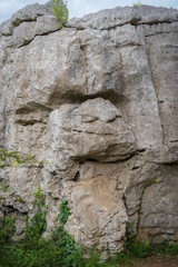 Sauve, France - 06 06 2019: monkey face drawn on stone in the sea of rocks