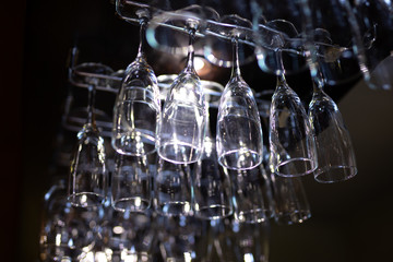 A lot of clean glasses hanging in a bar