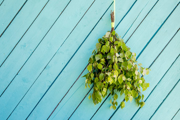Birch tree sauna whisk broom ( also known as vasta, vihta or venik) hanging and drying on the wall,...