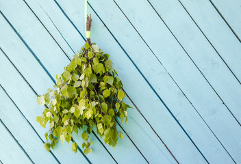 Birch tree sauna whisk broom ( also known as vasta, vihta or venik) hanging and drying on the wall,...