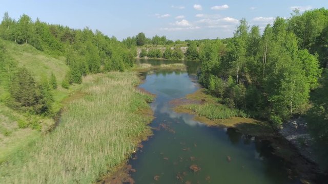 Flying in river canyon in old phosphorite and limestone mining site