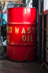Fototapeta na wymiar Red 55 gal drum of used automotive oil