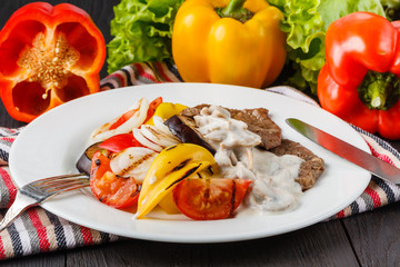 Grilled meat steak with vegetables in a plate
