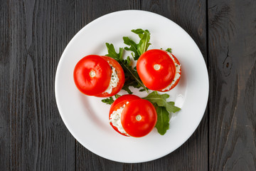 tomatoes stuffed with spinach, cheese and herbs, close up. Delicious and nutritious vegetarian meal