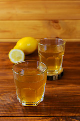 Kombucha in glasses on a wooden table.