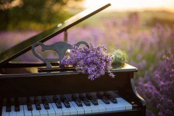  A bouquet of lavender lies on the of piano. Romantic spring backgroud