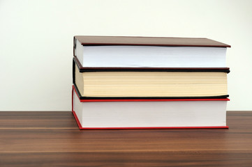 A stack of books on a light background with a field for writing text or inscriptions