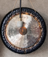 big gong percussion instrument hanging on a rope with mallet
