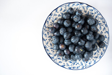 Fresh picked blueberries in a light and bright kitchen environment.