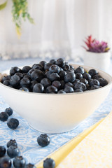 Fresh picked blueberries in a light and bright kitchen environment.