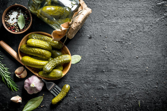 Pickled cucumbers on a plate and in a glass jar.