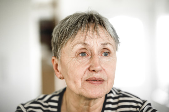 Portrait of senior woman with short hair, looking away