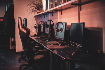 Photo of comfortable room for serious gamers with computers and earphones.