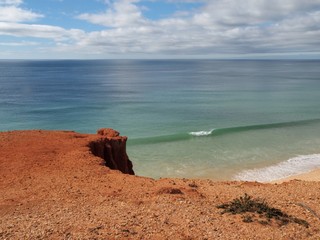 Red high cliffs at Praia da Falesia, a paradise beach in Albufeira in Portugal
