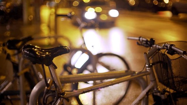 Barcelona city night. Steering wheel closeup. Mirror reflects light and colour. Cars and bikes moving on the background. European holidays. Nightlife in Barna. Shadows and background colour textures